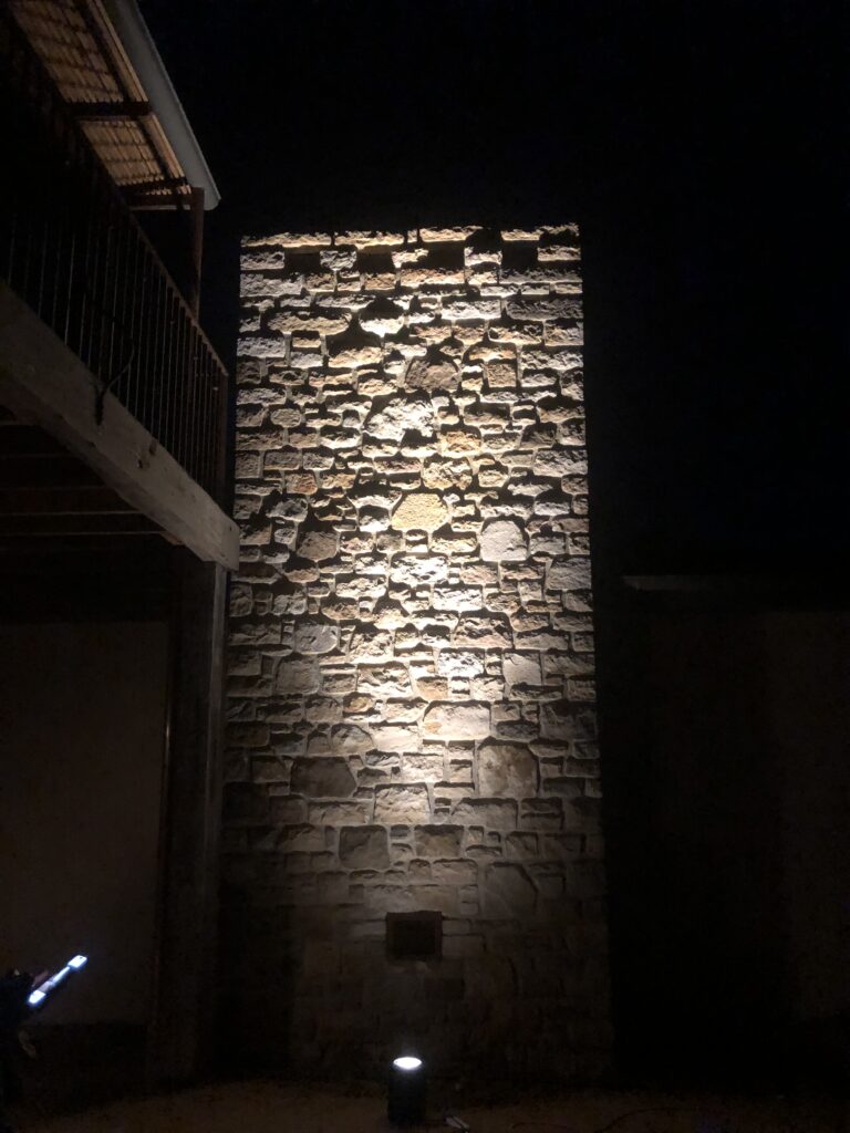 Home Electrician installed feature lighting on a stone wall in a home